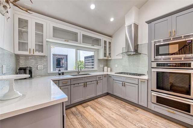 2008 Baja, Newport Beach, CA 92660 - kitchen with stainless steel appliances, a warming drawer, gray cabinets, wall chimney exhaust hood, and tasteful backsplash