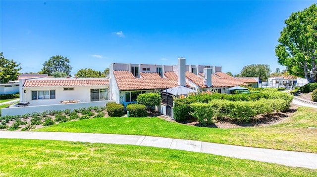 2008 Baja, Newport Beach, CA 92660 - view of front of property with a tile roof, stucco siding, and a front yard