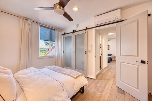 2008 Baja, Newport Beach, CA 92660 - bedroom with a wall unit AC, a barn door, recessed lighting, light wood-style floors, and ceiling fan
