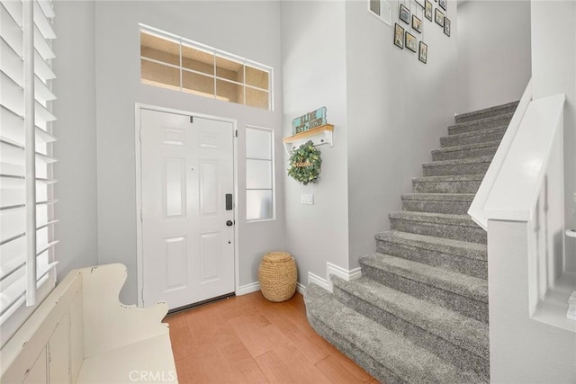 870 Clover Ln, Corona, CA 92878 - foyer featuring light wood-type flooring, stairs, and a high ceiling