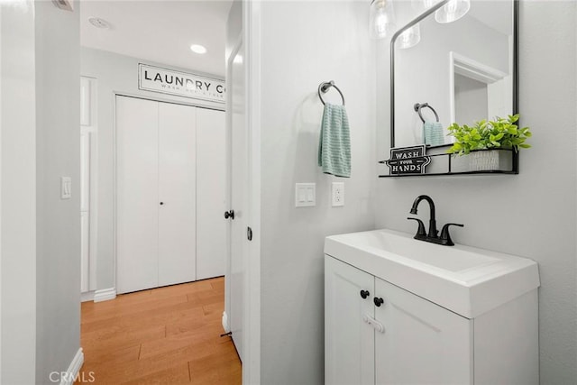 870 Clover Ln, Corona, CA 92878 - bathroom with vanity, wood finished floors, and recessed lighting