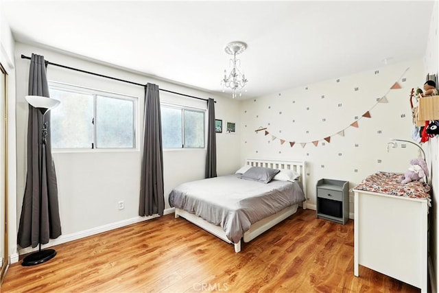 1739 E Broadway Unit 6, Long Beach, CA 90802 - bedroom featuring a chandelier and light wood-style flooring