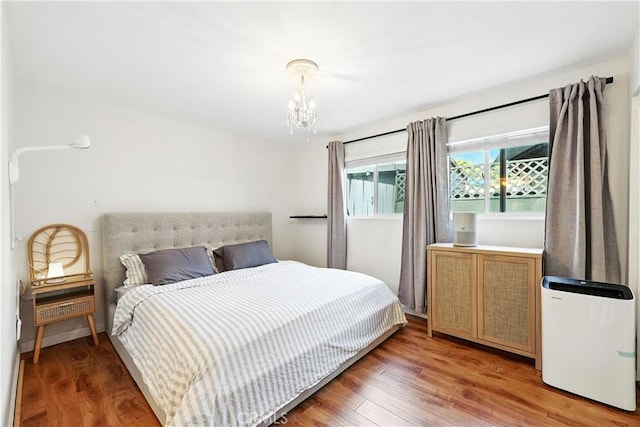 1739 E Broadway Unit 6, Long Beach, CA 90802 - bedroom with a chandelier and light wood finished floors