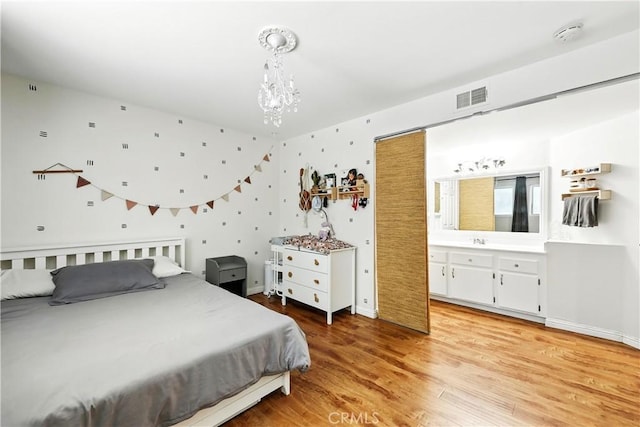 1739 E Broadway Unit 6, Long Beach, CA 90802 - bedroom with light wood-type flooring and a chandelier