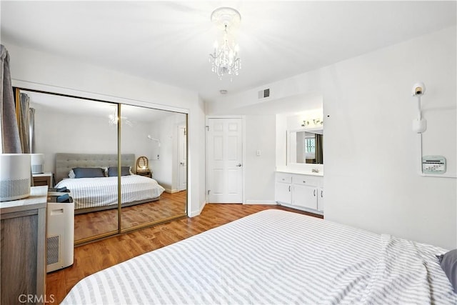 1739 E Broadway Unit 6, Long Beach, CA 90802 - bedroom featuring wood finished floors, a closet, and a chandelier