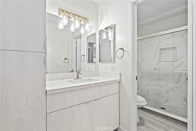 1745 Neil Armstrong St Unit 206, Montebello, CA 90640 - full bath with a marble finish shower, vanity, and wood finished floors