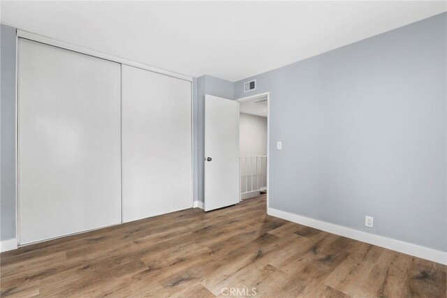1745 Neil Armstrong St Unit 206, Montebello, CA 90640 - unfurnished bedroom with wood finished floors and a closet
