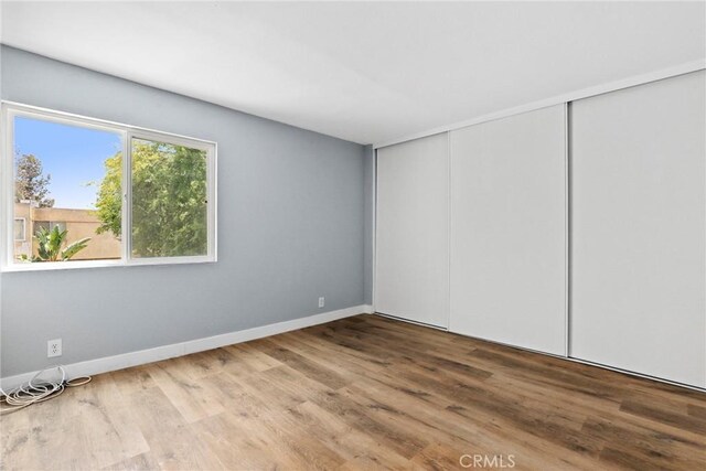 1745 Neil Armstrong St Unit 206, Montebello, CA 90640 - unfurnished bedroom featuring wood finished floors and a closet
