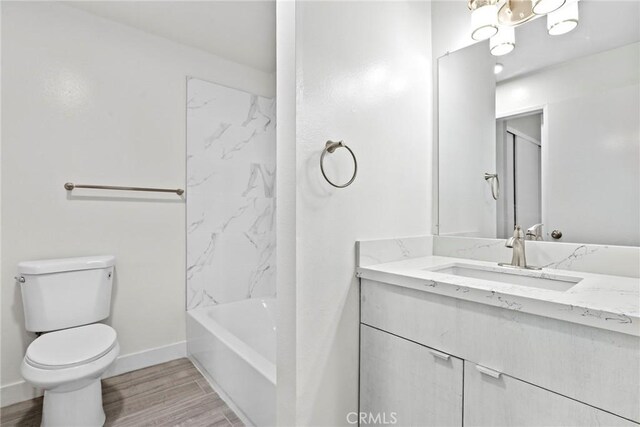 1745 Neil Armstrong St Unit 206, Montebello, CA 90640 - full bath featuring vanity, wood finished floors, and washtub / shower combination