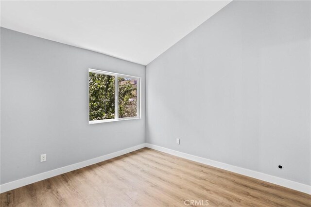 1745 Neil Armstrong St Unit 206, Montebello, CA 90640 - spare room with light wood-style flooring and vaulted ceiling