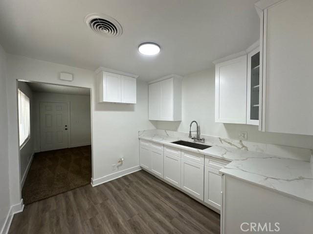 211-215 E California Ave, Ridgecrest, CA 93555 - kitchen featuring dark wood-style flooring, white cabinets, light stone countertops, and glass insert cabinets