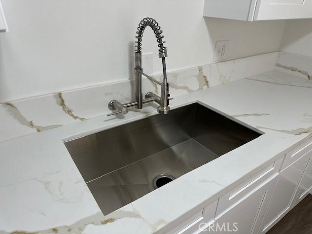 211-215 E California Ave, Ridgecrest, CA 93555 - kitchen view of white cabinets and light stone countertops