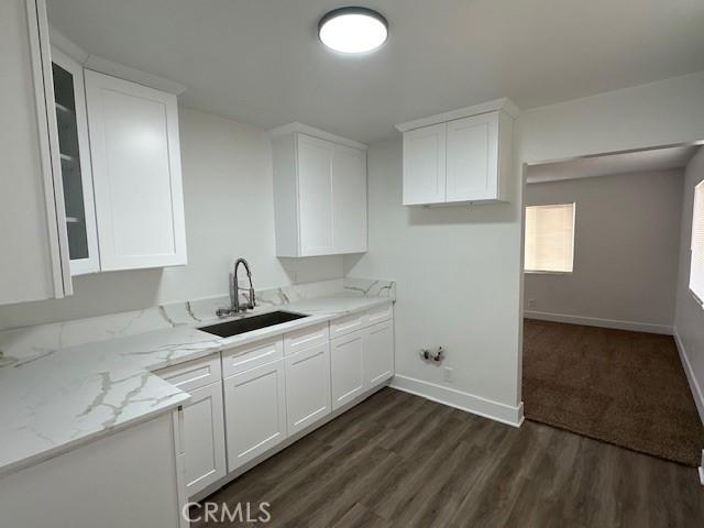 211-215 E California Ave, Ridgecrest, CA 93555 - kitchen featuring white cabinets, glass insert cabinets, light stone counters, and dark wood finished floors