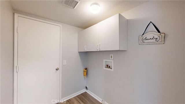 8007 New Salem St, San Diego, CA 92126 - laundry area with cabinet space, wood finished floors, hookup for a washing machine, and a textured ceiling