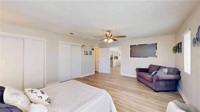 8007 New Salem St, San Diego, CA 92126 - bedroom with two closets, light wood finished floors, and ceiling fan