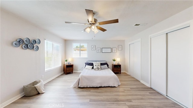 8007 New Salem St, San Diego, CA 92126 - bedroom featuring two closets, light wood finished floors, and a ceiling fan