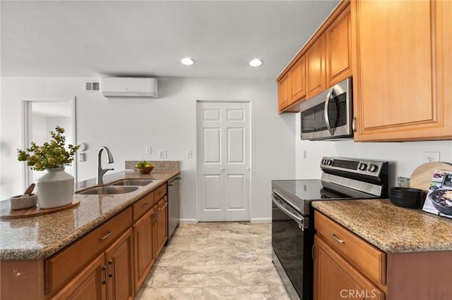 21981 Rimhurst Dr Unit 158, Lake Forest, CA 92630 - kitchen featuring stainless steel appliances, an AC wall unit, a peninsula, stone counters, and recessed lighting
