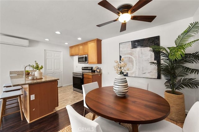 21981 Rimhurst Dr Unit 158, Lake Forest, CA 92630 - dining room with an AC wall unit, wood finished floors, ceiling fan, and recessed lighting