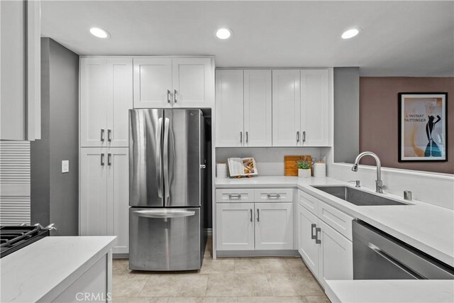 23957 Arroyo Park Dr Unit 146, Valencia, CA 91355 - kitchen with stainless steel appliances, light countertops, white cabinets, and recessed lighting