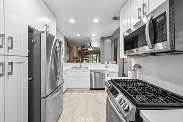 23957 Arroyo Park Dr Unit 146, Valencia, CA 91355 - kitchen with stainless steel appliances, ceiling fan, recessed lighting, light countertops, and white cabinets