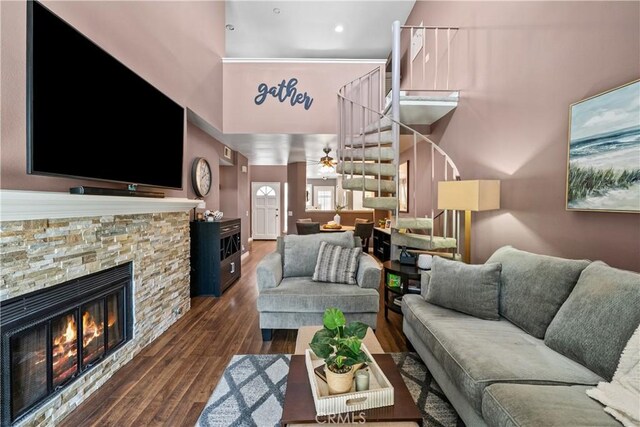 23957 Arroyo Park Dr Unit 146, Valencia, CA 91355 - living room featuring a fireplace, wood finished floors, stairway, and a towering ceiling