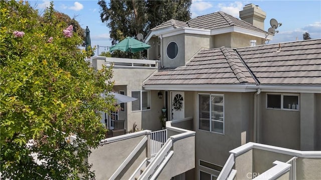 23957 Arroyo Park Dr Unit 146, Valencia, CA 91355 - entrance to property featuring a tiled roof, stucco siding, and a chimney