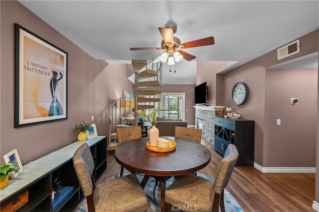 23957 Arroyo Park Dr Unit 146, Valencia, CA 91355 - dining room featuring wood finished floors, ceiling fan, and a fireplace