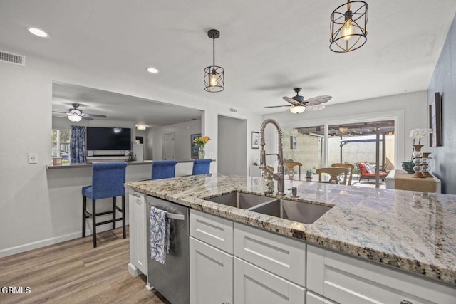 3151 W Hemlock St, Oxnard, CA 93035 - kitchen with ceiling fan, stainless steel dishwasher, white cabinets, light wood-style flooring, and recessed lighting