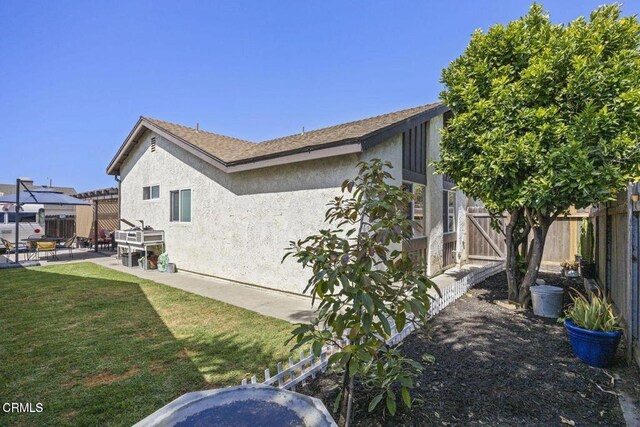 3151 W Hemlock St, Oxnard, CA 93035 - view of side of home with a patio, stucco siding, and a fenced backyard