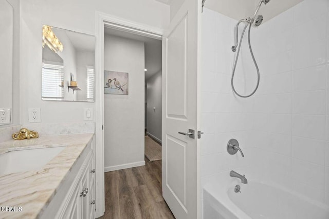 3151 W Hemlock St, Oxnard, CA 93035 - bathroom with vanity, washtub / shower combination, and wood finished floors