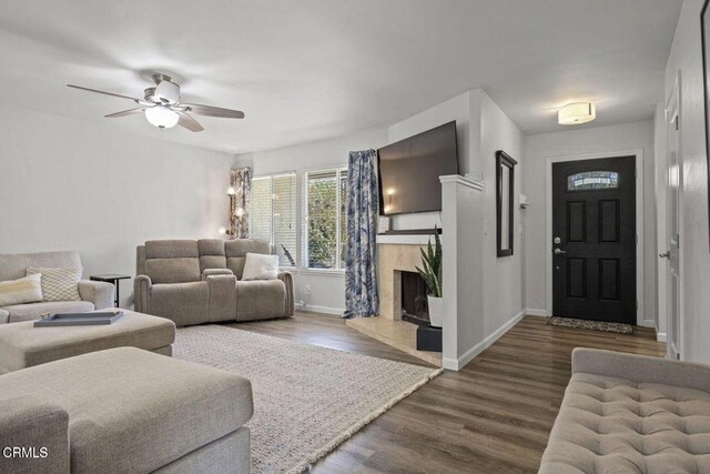 3151 W Hemlock St, Oxnard, CA 93035 - living area featuring ceiling fan, dark wood-style floors, and a premium fireplace