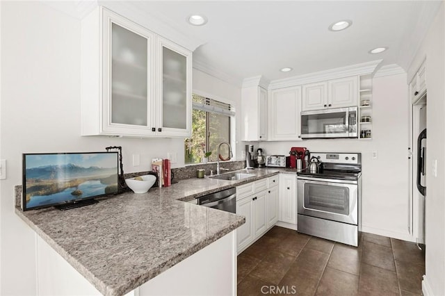422 Cypress St, Laguna Beach, CA 92651 - kitchen with stainless steel appliances, a peninsula, white cabinetry, light stone countertops, and recessed lighting