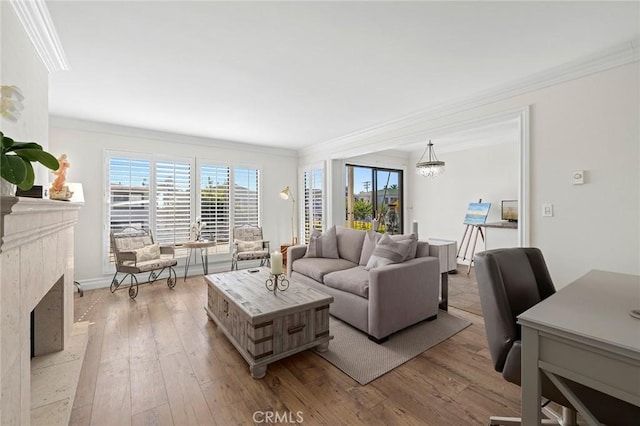 422 Cypress St, Laguna Beach, CA 92651 - living area with ornamental molding, light wood-style flooring, a premium fireplace, and a chandelier