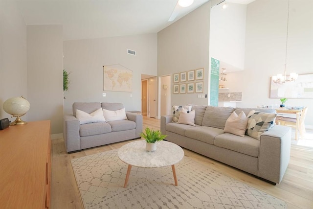 7083 Deerhurst Ct, San Diego, CA 92139 - living room featuring a chandelier, light wood-style flooring, and high vaulted ceiling