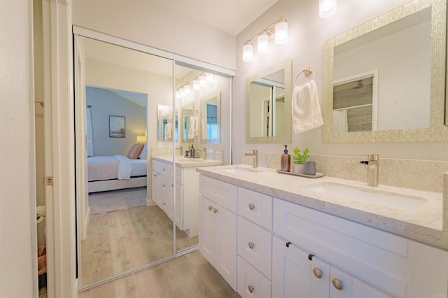 7083 Deerhurst Ct, San Diego, CA 92139 - full bathroom featuring wood finished floors, double vanity, ensuite bathroom, and a shower