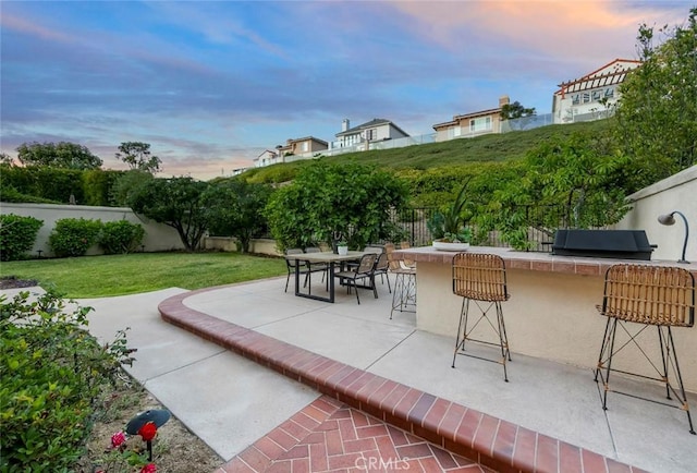 14 Pavona, Newport Coast, CA 92657 - patio terrace at dusk with a fenced backyard, a patio area, and grilling area