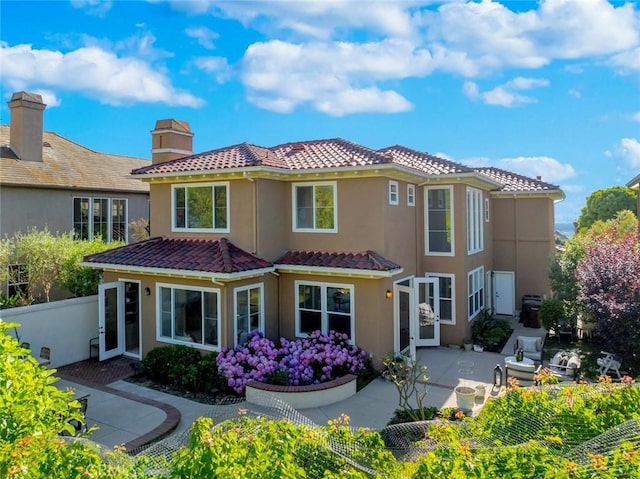 14 Pavona, Newport Coast, CA 92657 - back of property featuring a patio, a tiled roof, stucco siding, and a chimney