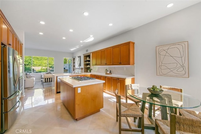14 Pavona, Newport Coast, CA 92657 - kitchen with appliances with stainless steel finishes, recessed lighting, a center island, light countertops, and brown cabinets