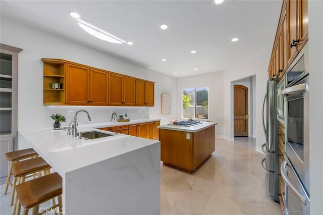 14 Pavona, Newport Coast, CA 92657 - kitchen featuring appliances with stainless steel finishes, brown cabinetry, a center island, a peninsula, and recessed lighting