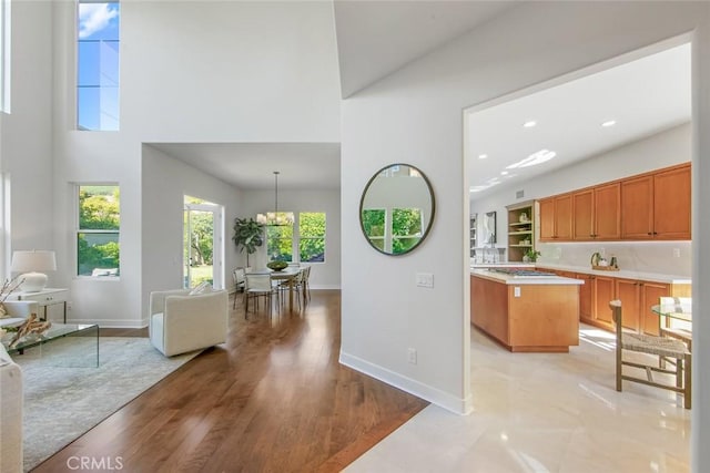 14 Pavona, Newport Coast, CA 92657 - kitchen featuring light countertops, open floor plan, brown cabinets, a center island, and light wood finished floors