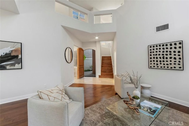 14 Pavona, Newport Coast, CA 92657 - living room with stairway, arched walkways, a high ceiling, and wood finished floors