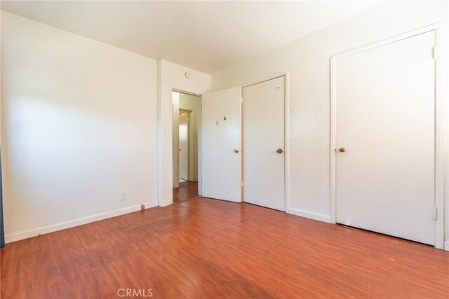 1132 E 65th St, Los Angeles, CA 90001 - unfurnished bedroom featuring wood finished floors