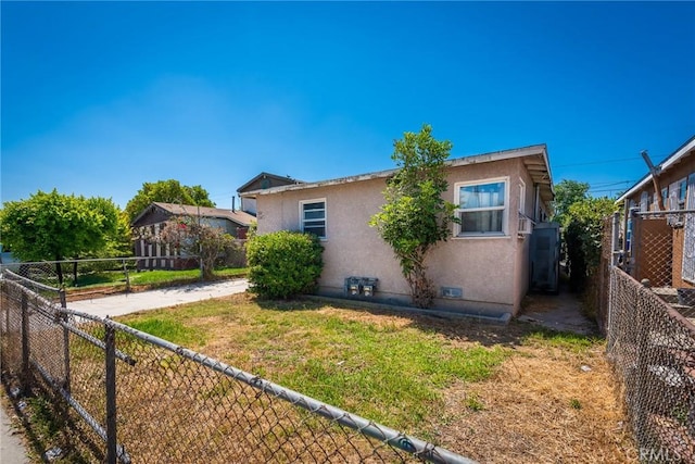 1132 E 65th St, Los Angeles, CA 90001 - view of property exterior featuring stucco siding and a fenced backyard