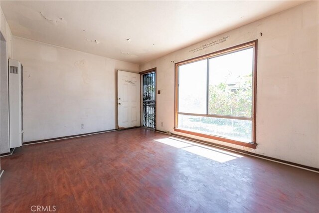 1132 E 65th St, Los Angeles, CA 90001 - empty room with wood finished floors and baseboards