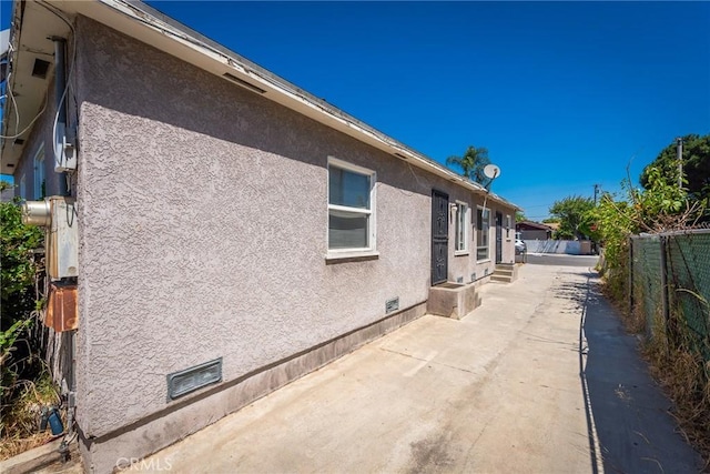 1132 E 65th St, Los Angeles, CA 90001 - view of property exterior featuring stucco siding and a patio