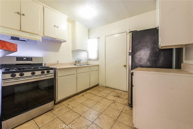 1132 E 65th St, Los Angeles, CA 90001 - kitchen featuring stainless steel range with gas cooktop, under cabinet range hood, light countertops, and light tile patterned floors