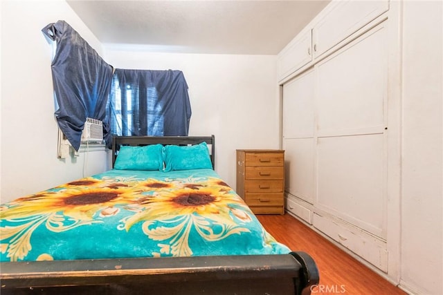 1132 E 65th St, Los Angeles, CA 90001 - bedroom with wood finished floors, cooling unit, and a closet