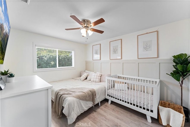 330 Glenshaw Dr, La Puente, CA 91744 - bedroom with wood finished floors, a wainscoted wall, a decorative wall, and ceiling fan
