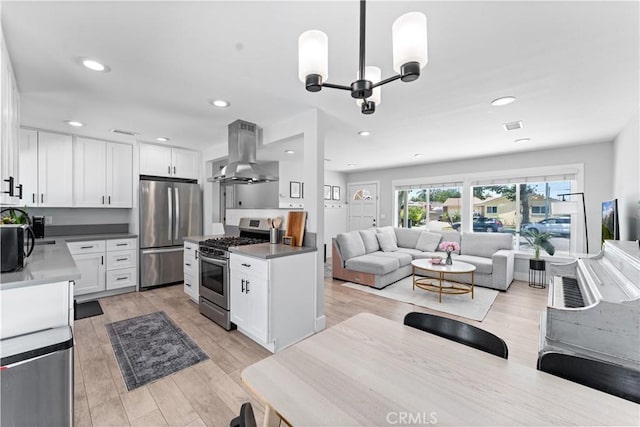 330 Glenshaw Dr, La Puente, CA 91744 - kitchen with ventilation hood, appliances with stainless steel finishes, open floor plan, white cabinets, and recessed lighting