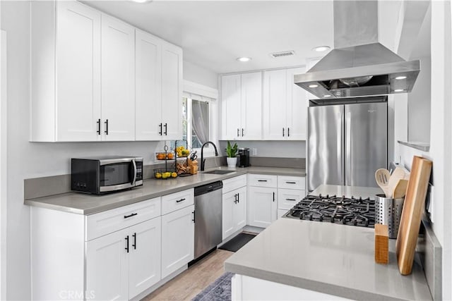 330 Glenshaw Dr, La Puente, CA 91744 - kitchen featuring island range hood, stainless steel appliances, recessed lighting, light wood-type flooring, and white cabinetry